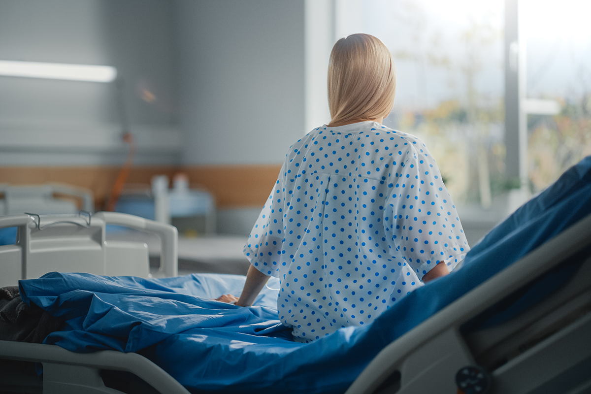 beautiful caucasian female patient sitting on a bed
