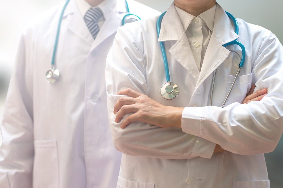 medical doctor or physician team in white gown uniform with stethoscope in hospital
